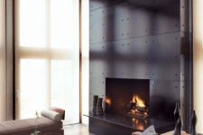 16 a fireplace accentuated with black metal panels looks chic and a bit industrial