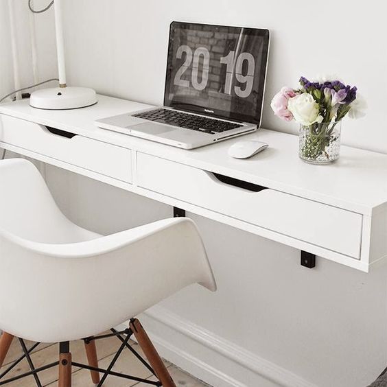 a comfy white floating desk with a couple of drawers for hiding some stuff