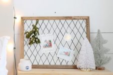 17 a small pinboard upholstered with fabric with a grid print and a refined vintage frame