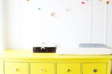 18 IKEA Hemnes hack in bold yellow with different knobs for a bold nursery