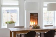 19 a gorgeous built-in fireplace in the dining room makes it cozy and highlights the space