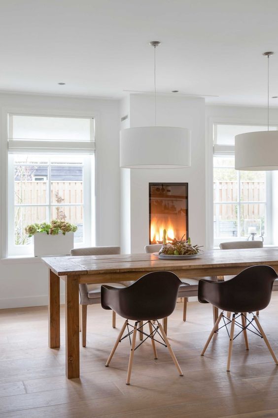 a gorgeous built-in fireplace in the dining room makes it cozy and highlights the space