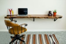 20 a floating desk of a wooden slab with a live edge will bring a natural touch