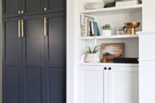 20 navy paneled front doors plus brass handles give a Pax item a chic look