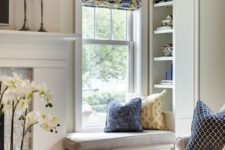 22 a small and comfy windowsill seat with upholstery and built-in shelves