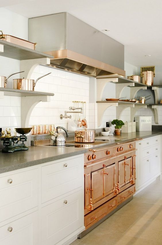 a vintage-inspired copper cooker and hood are the main pieces, and stainless steel touches look harmonious