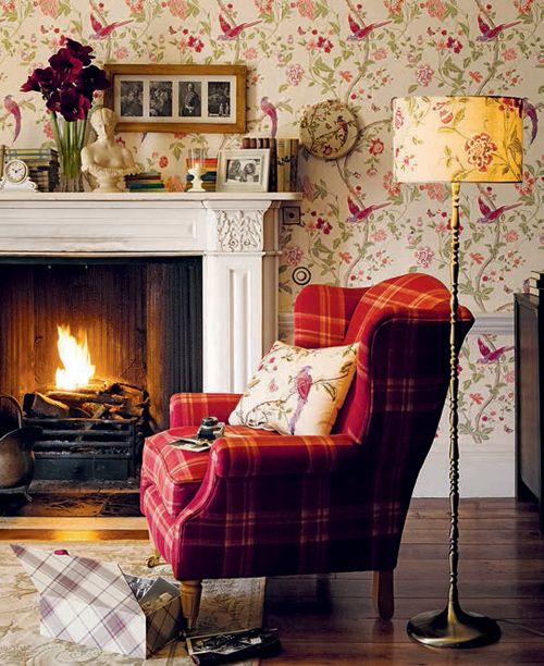 an English country living room with colorful flora and fauna print wallpaper to add to the style