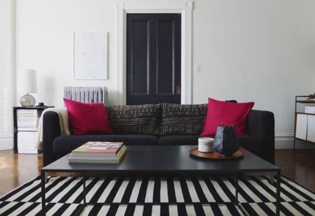 a Stockholm rug and sofa for a monochrome interior and a couple of fuchsia pillows for a colorful splash