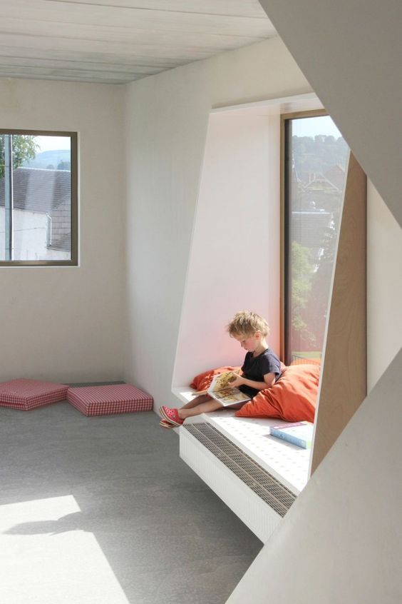 a windowsill with a comfy seat can be used as a reading space for a kid