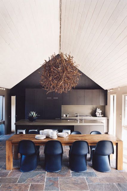 highlight the ceiling with a driftwood chandelier and a contrasting black wall