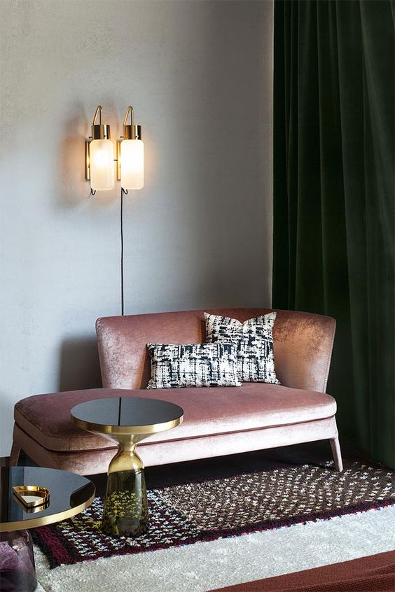 a shiny pink daybed looks very refined and is highlighted with gold rim side tables