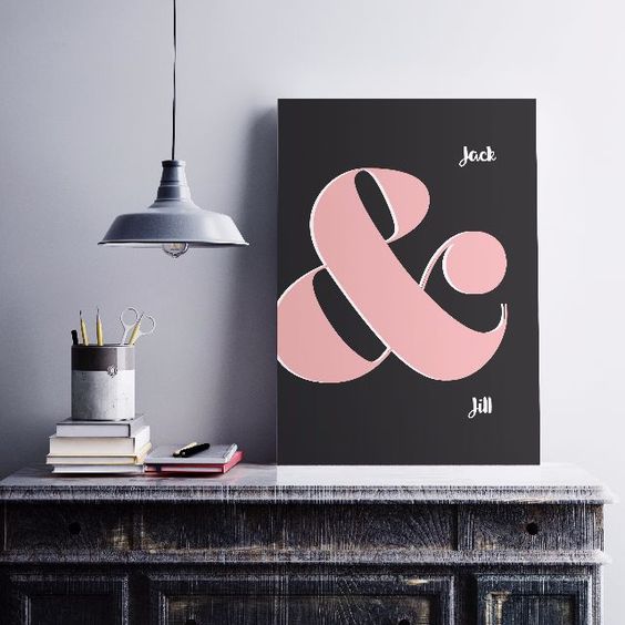 a stylish modern ampersand sign with a black backdrop and a large pink ampersand
