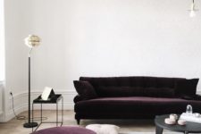 26 a dark aubergine sofa and ottoman make a bold statement and nearly make up the space