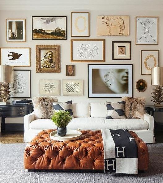 a large brown leather ottoman brings a touch of color and texture to this living room