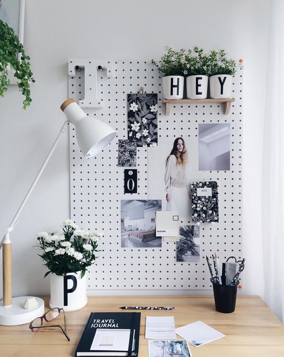 A pegboard is an ideal pinboard and you may attach shelves and other stuff to it
