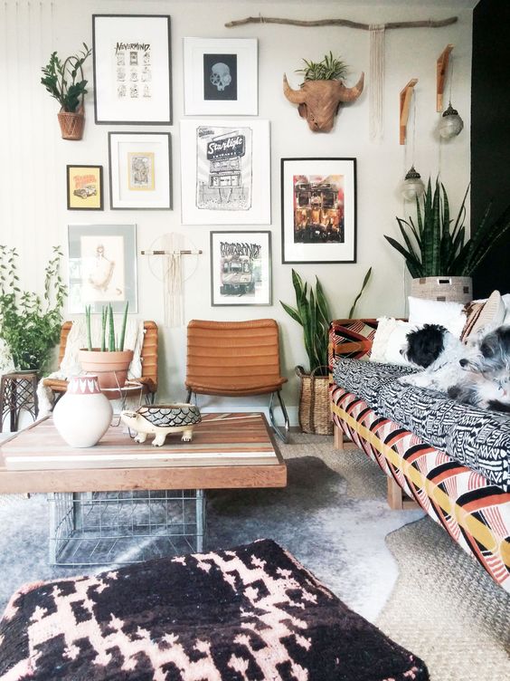 a boho living room with a cool gallery wall and boho-inspired art pieces