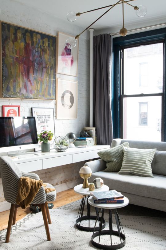 a white floating desk in the corner of the room doesn't require much space