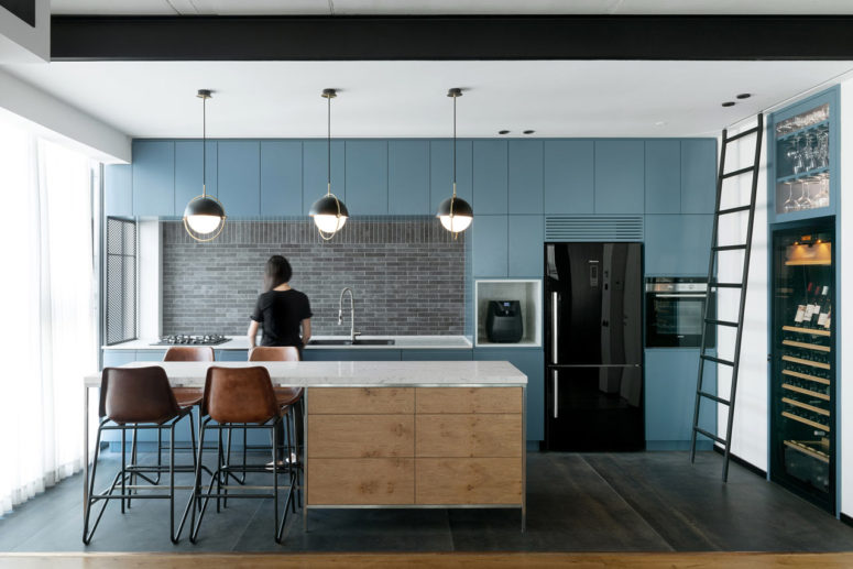 This contemporary apartment features an open layout, functional interiors and stylish touches of industrial aesthetics