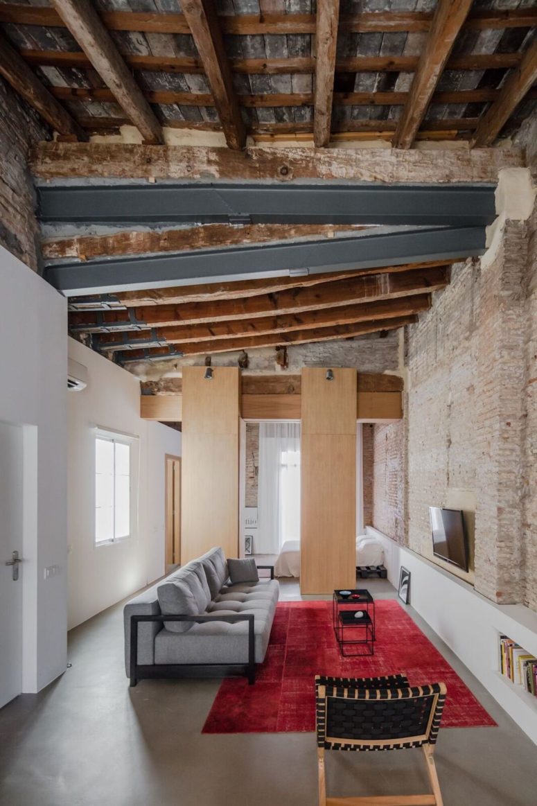 This modern apartment was renovated with focusing on the old features and preserving them for giving it a character
