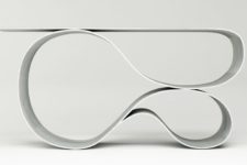 01 Whorl console table is made of fabric concrete and it features a unique shape