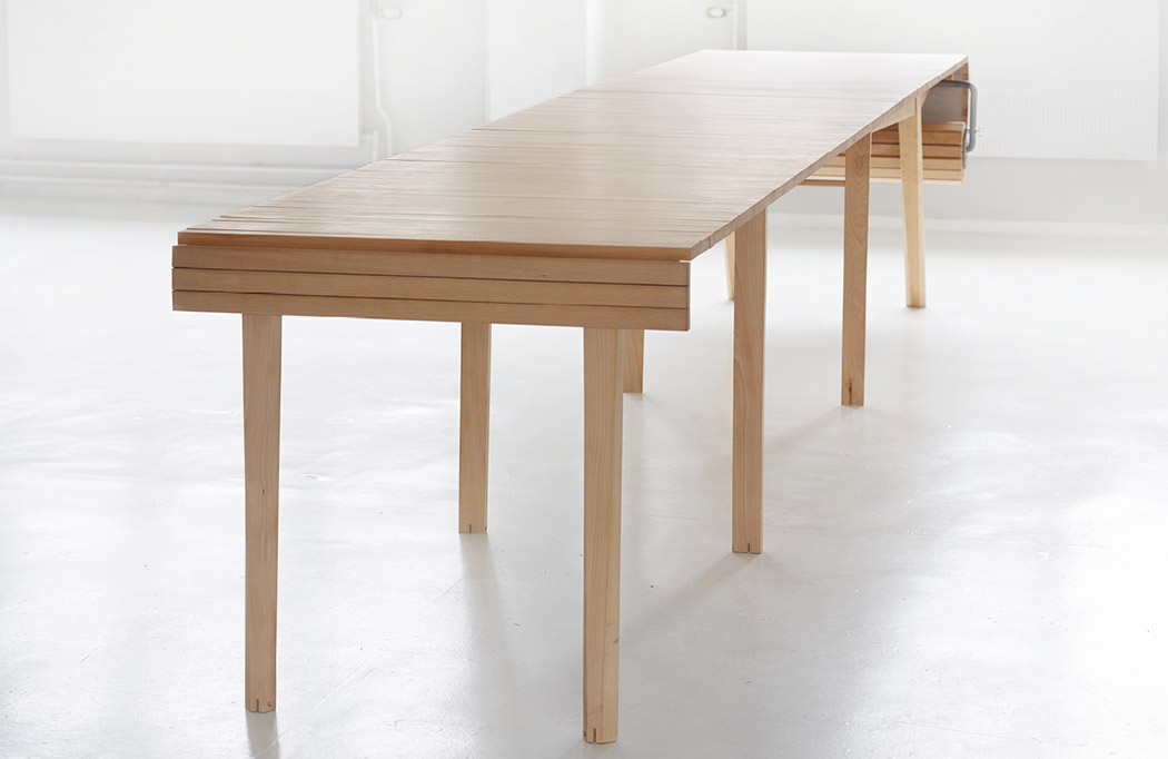 The table features some wooden slats and a crank to make it larger or smaller when needed