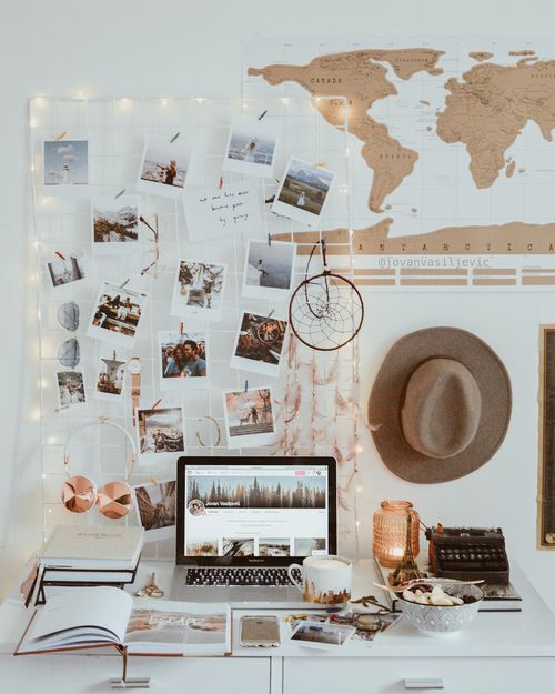 a chic white grid board covered with string lights to accent it and inspire the person