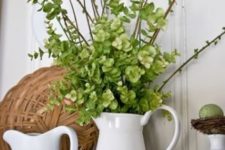 02 a jug with greenery and green hydrangeas, green speckled eggs and some white porcelain