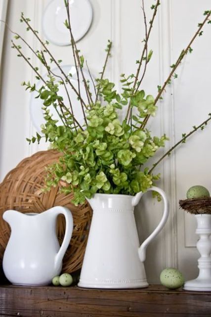 a jug with greenery and green hydrangeas, green speckled eggs and some white porcelain