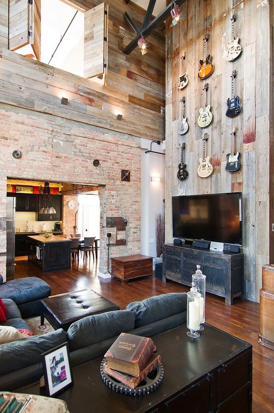 a loft with a masculine feel and a guitar display over the TV