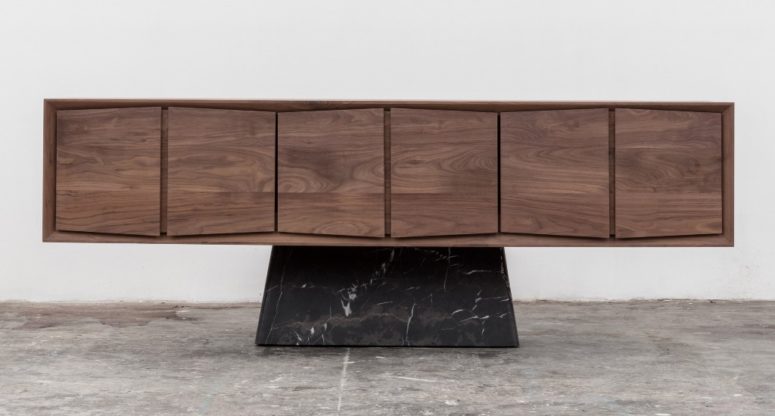The Trinchador credenza features wooden cabinets with a 3D effect and a black marble bse