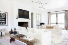 03 The living room is a gorgeous large space filled with whites and light, a fireplace and some rustic touches that add coziness