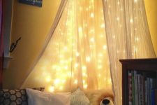 03 a bed canopy with lots of string lights works as a night light if necessary