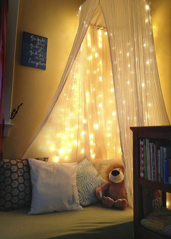 a bed canopy with lots of string lights works as a night light if necessary