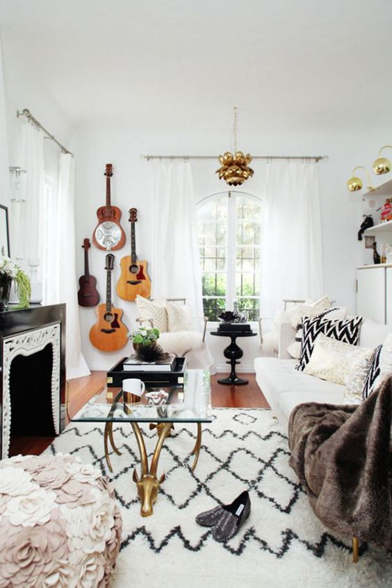 a boho living room accented with guitars on the wall in the corner