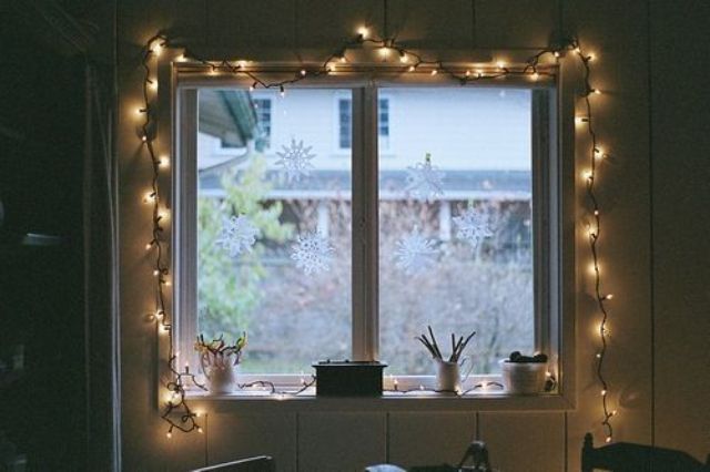 highlighting the window with string lights is a cute and chic idea to add more light inside