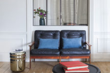 04 A leather upholstered loveseat and a metallic side table are perfect for the space