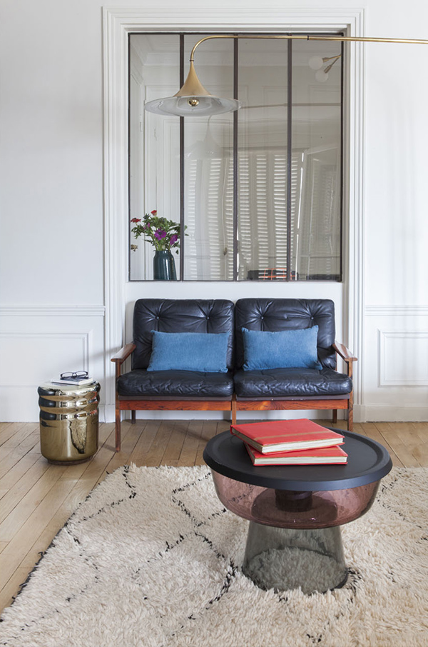 A leather upholstered loveseat and a metallic side table are perfect for the space