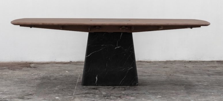 The Dolmen dining table is placed on a black marble base, too and has interesting edges