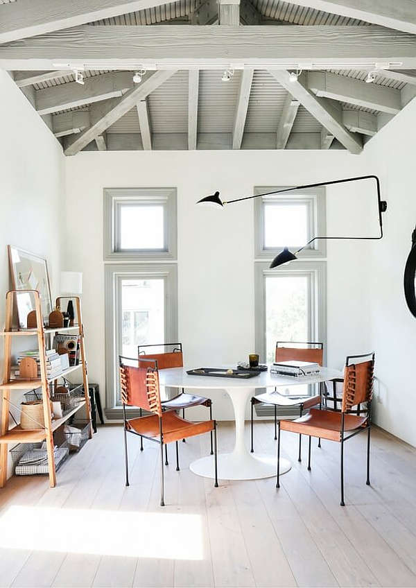 The home office or designer's studio is done with industrial touches   just look at those metal and leather chairs