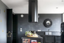 04 The kitchen is done with a lot of black – black walls, tiles, appliances, cabinets