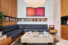 04 The living room is done with a large corner sofa, a built-in bookshelf and is centered around the fireplace