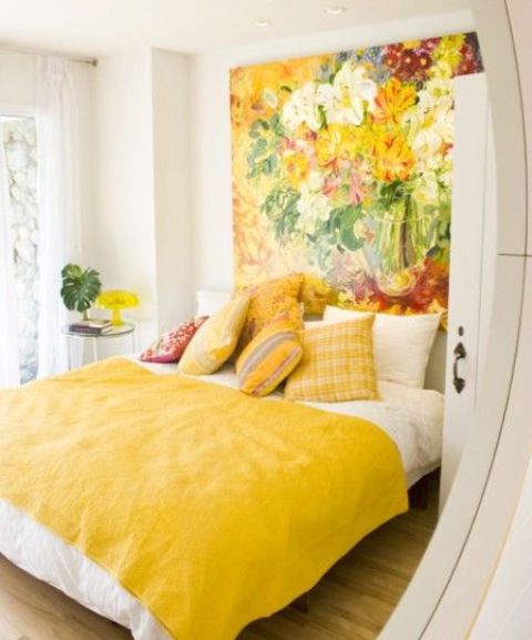 a whole headboard wall taken by a bold flower artwork in spring shades