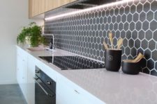 04 black hexagon tiles with white grout bring a stylish geo touch to the space