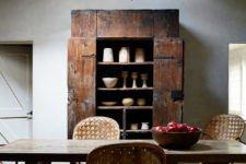 05 The dining space shows off a fantastic antique weathered cupboard, some woven chairs and a rustic dining table