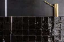 05 a masculine kitchen with glossy black tiles that highlight the man-like feel