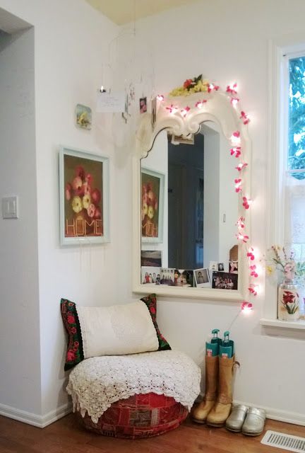 a feminine entryway decor with a mirror covered with string lights and pink touches for a girlish feel here