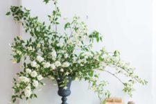 05 billowing branches of mock orange in an iron urn for beautiful and refined decor