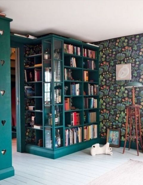 colorful bookshelves with glass inserts match the interior and accent the books with their bold color