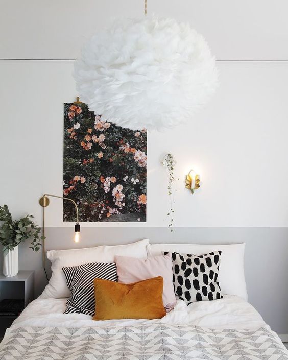 a pretty floral wall art and a fluffy chandelier that reminds of a large bloom