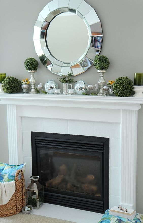 boxwood balls and eggs in glasses are all you need for a stylish spring mantel